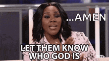a woman is sitting on a couch with her hands in her pockets and says `` amen let them know who god is '' .