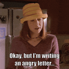 a woman is wearing a yellow hat and says okay but i 'm writing an angry letter