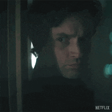 a close up of a man 's face behind a door with a netflix logo in the corner .