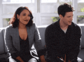 a man and a woman are sitting on a couch .