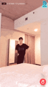 a man in a black shirt is dancing in a room with a vlive logo
