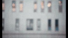a blurred image of a building with a lot of windows