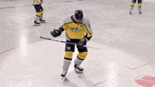 a hockey player in a yellow and black jersey with the number 14 on it