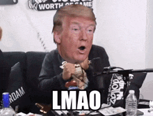 a man sitting in front of a microphone with a donald trump head on his head and the word lmao on the bottom