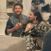 a man and a woman are sitting next to each other