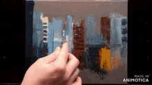 a person is painting on a canvas with the words made in animotica on the bottom right