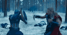 captain america and thor are fighting in a snowy forest .