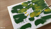 a painting of a tree is being painted on a piece of paper