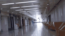 a long hallway with a sign on the wall that says ' emergency '