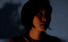 a close up of a woman 's face against a dark background