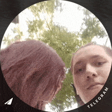 a man and a woman are looking at each other in a circle that says telegram