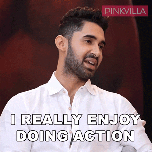 a man in a white shirt is saying i really enjoy doing action