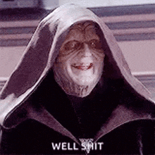 the emperor from star wars is smiling and wearing a hooded cloak .