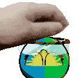a hand is holding a small globe with a picture of a landscape on it .