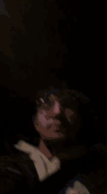 a blurry picture of a person 's face with a light behind them