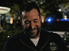a man with a beard wearing a badge that says ' l.a.p.d. ' on it