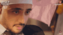 a close up of a man 's face with the words colors on the bottom left