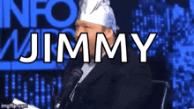 a man with a bandana on his head is sitting in front of a microphone and the name jimmy is displayed above him