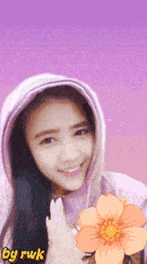 a girl wearing a purple hoodie has a flower in front of her and the words by ruk on the bottom right