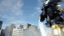 a robot is flying through the air with a city in the background
