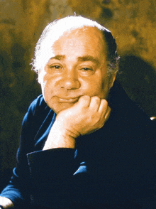 a man with his hand resting on his chin