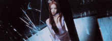 a woman is standing in front of a broken glass door .