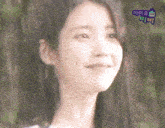 a close up of a woman 's face with a purple sticker that says ' iu ' on it