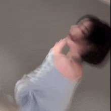 a blurry picture of a woman with short hair waving