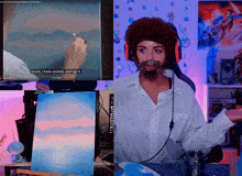 a woman in a bob ross costume is sitting in front of a computer monitor