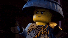 a close up of a lego man with a surprised look on his face and a hat .