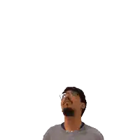 a man with glasses looks up at a green cross on his head