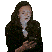 a woman in a black shirt is holding a cell phone