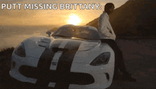 a man sits on the front of a white sports car with the words putt missing brittany written above him