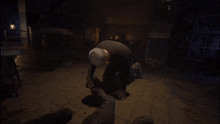 a man is kneeling down on the floor in a dark room with the words `` the noosphere '' written on the bottom .
