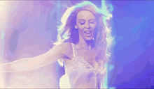 a woman is dancing in front of a blue light