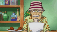 a man in a hat holds a piece of paper with the letter s on his shirt