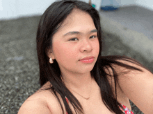 a woman in a bikini is taking a selfie