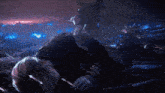 a man is laying on the ground with a sword in his hand in a dark room