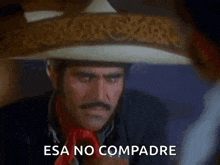 a man wearing a sombrero with the words esa no compadre written on it