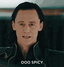 a close up of a man 's face with the words `` ooo spicy '' written below it .