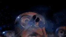 a blurred image of a person 's face with a rainbow in the background