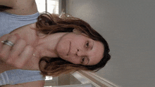 a woman wearing a striped tank top is smiling