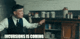 a man in a suit and tie is standing in a kitchen and pointing at something .