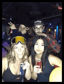 a man wearing a thrasher hat is standing next to two women