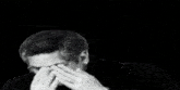 a man with glasses and a mustache looks down at something