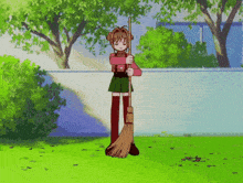 a girl is holding a broom and standing on a lush green field