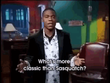 a man in a suit and a floral shirt says what 's more classic than sasquatch