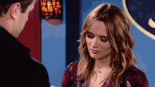 a man and a woman are looking at each other and the woman is wearing a leopard print top
