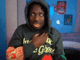a man wearing a hoodie with the word ghost on the front