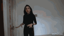 a woman is standing in front of a door that says door queen inc. on it